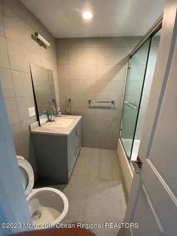 a view of a backyard with table and chairs with wooden fence