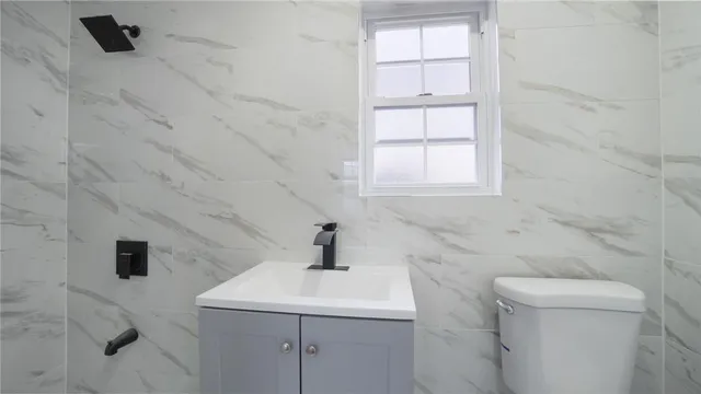 a bathroom with a sink a toilet and window
