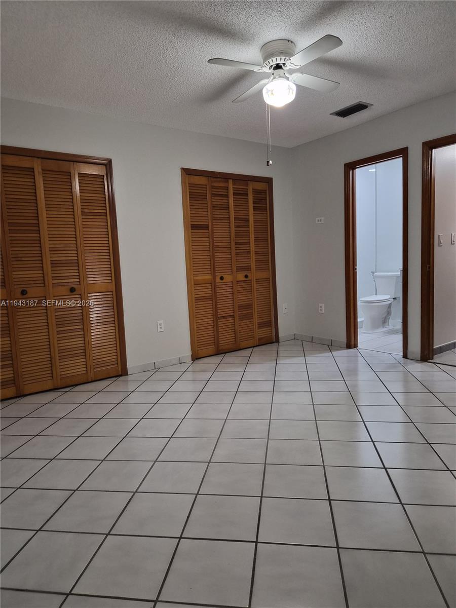 1453 Southwest 137th Place Miami, FL 33184 - Photo 16 of 22 a view of a livingroom with an empty space and a ceiling fan