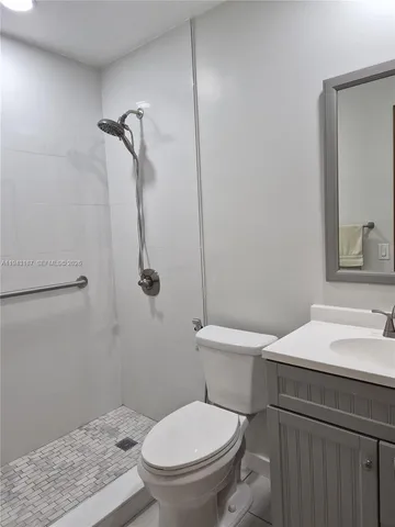 a white toilet sitting next to a bathroom sink
