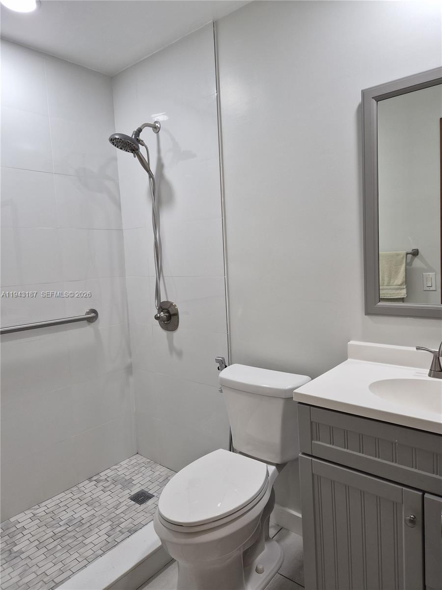 1453 Southwest 137th Place Miami, FL 33184 - Photo 17 of 22 a white toilet sitting next to a bathroom sink