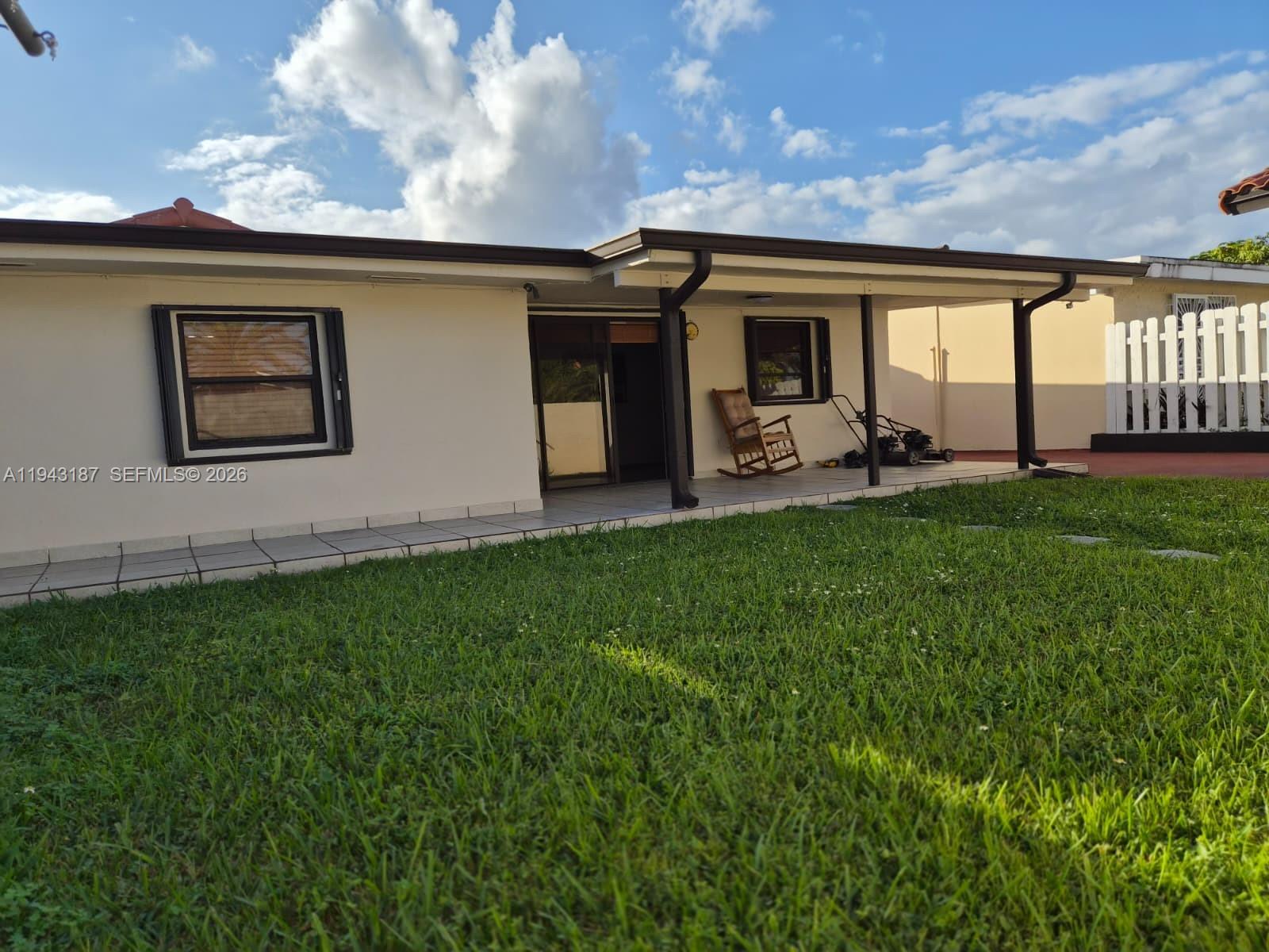 1453 Southwest 137th Place Miami, FL 33184 - Photo 2 of 22 a front view of house with yard and porch