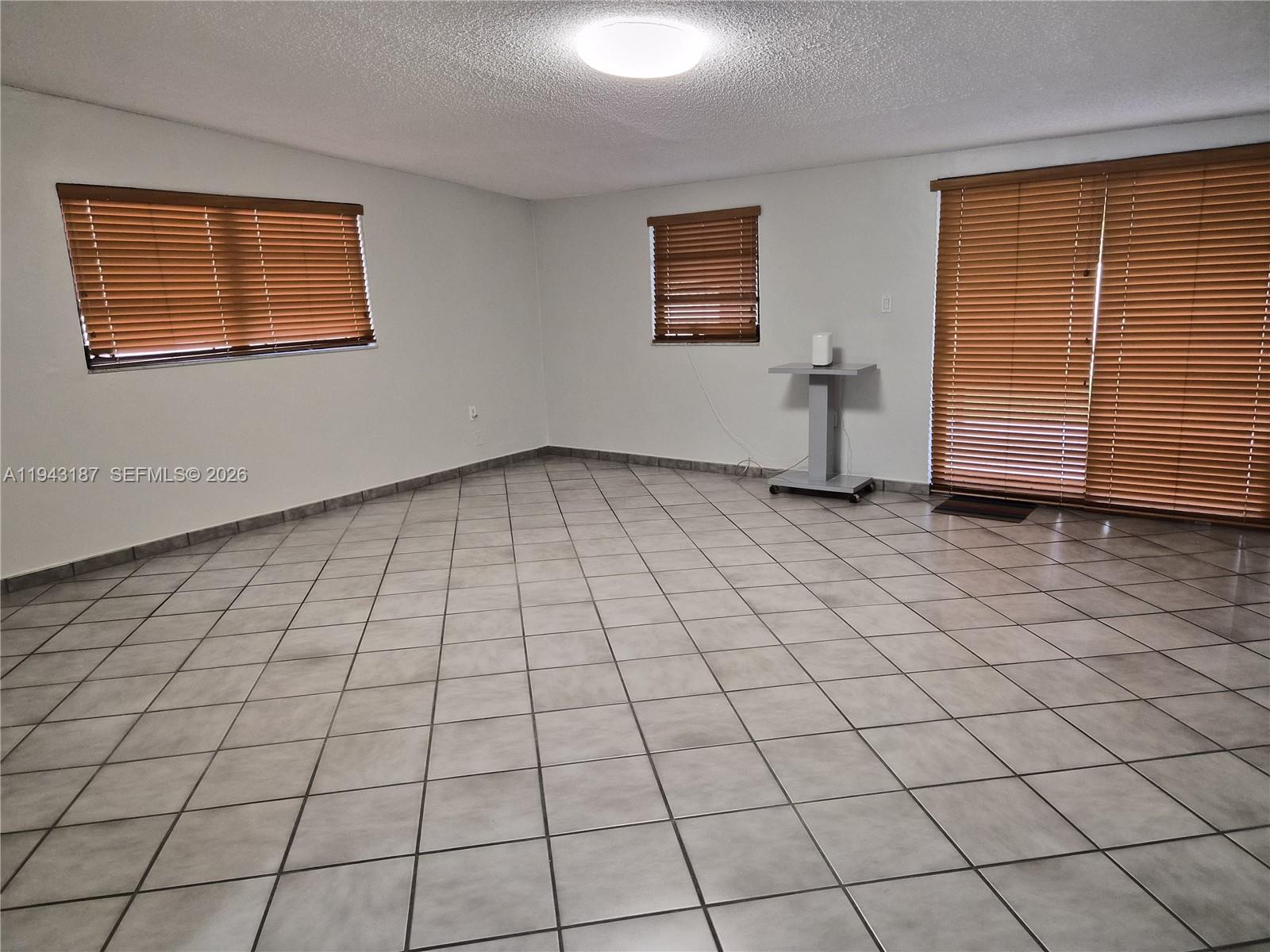 1453 Southwest 137th Place Miami, FL 33184 - Photo 9 of 22 an empty room with windows