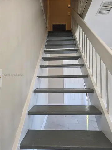 a view of staircase and living room with windows