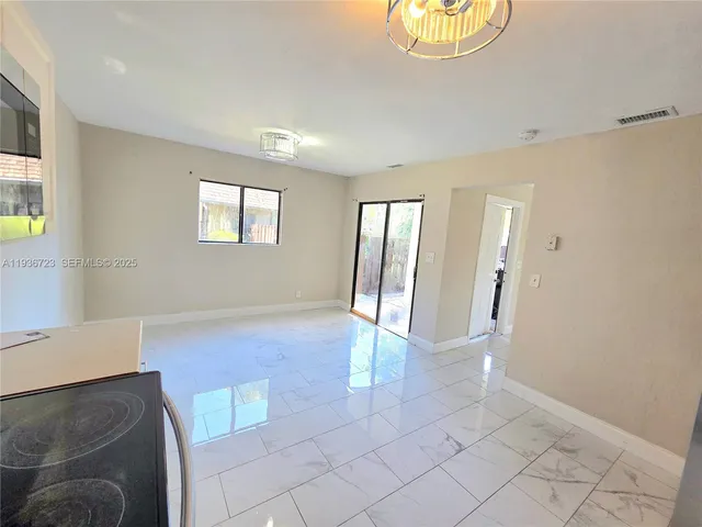 a kitchen with granite countertop a stove and a sink