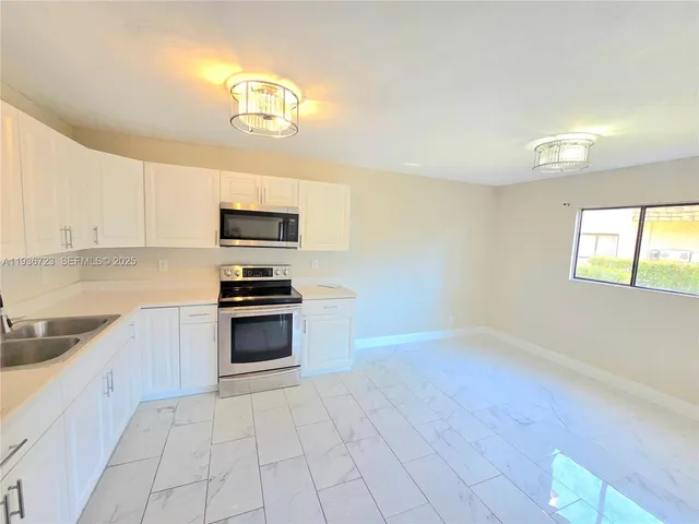 a kitchen with stainless steel appliances a refrigerator and a stove