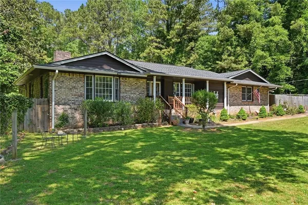 a front view of a house with a garden and porch
