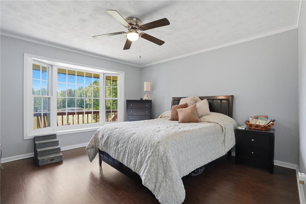 5737 Highway 20 Covington, GA 30016 - Photo 12 of 22 a spacious bedroom with a bed and a large window