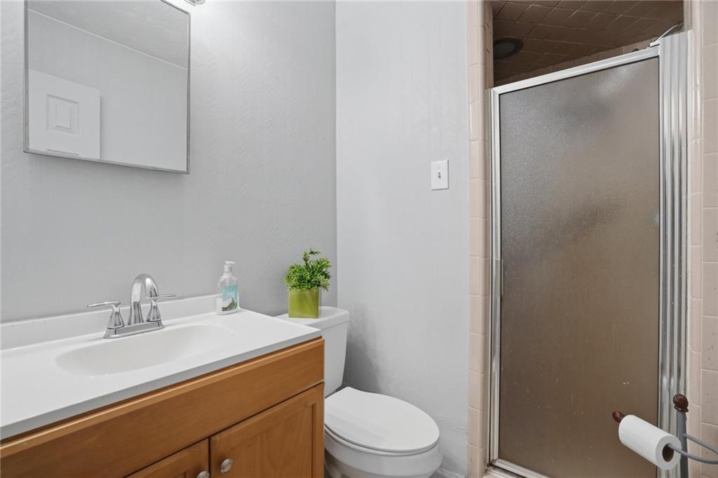 5737 Highway 20 Covington, GA 30016 - Photo 13 of 22 a bathroom with a sink a toilet and shower