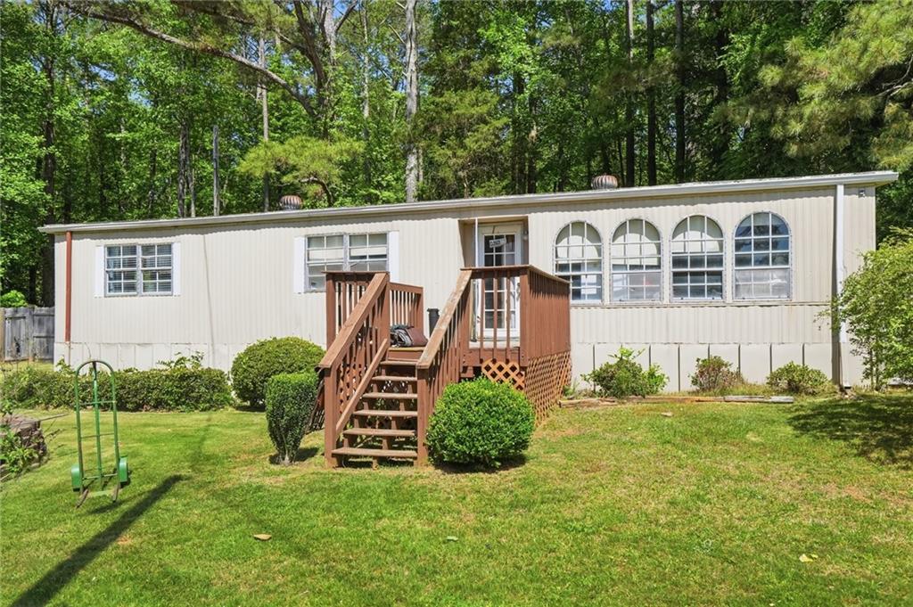 5737 Highway 20 Covington, GA 30016 - Photo 18 of 22 a front view of a house with garden