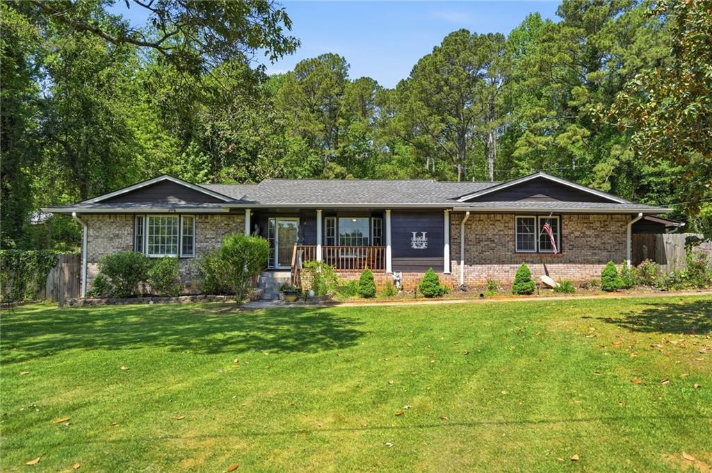 5737 Highway 20 Covington, GA 30016 - Photo 3 of 22 a front view of a house with a yard table and chairs