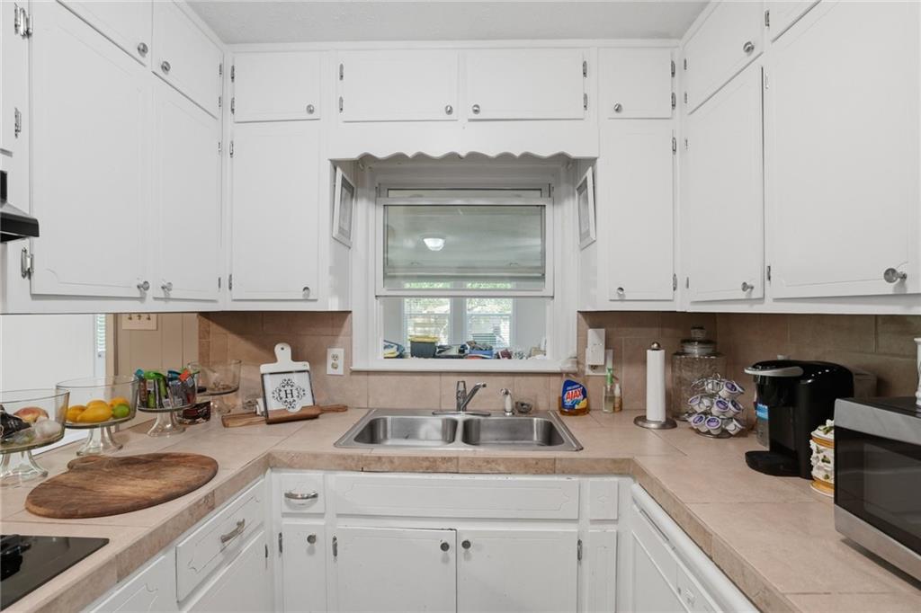 5737 Highway 20 Covington, GA 30016 - Photo 8 of 22 a kitchen with white cabinets and a sink