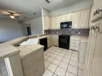 a kitchen with a stove a sink and a microwave