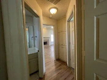 a view of a hallway with wooden floor