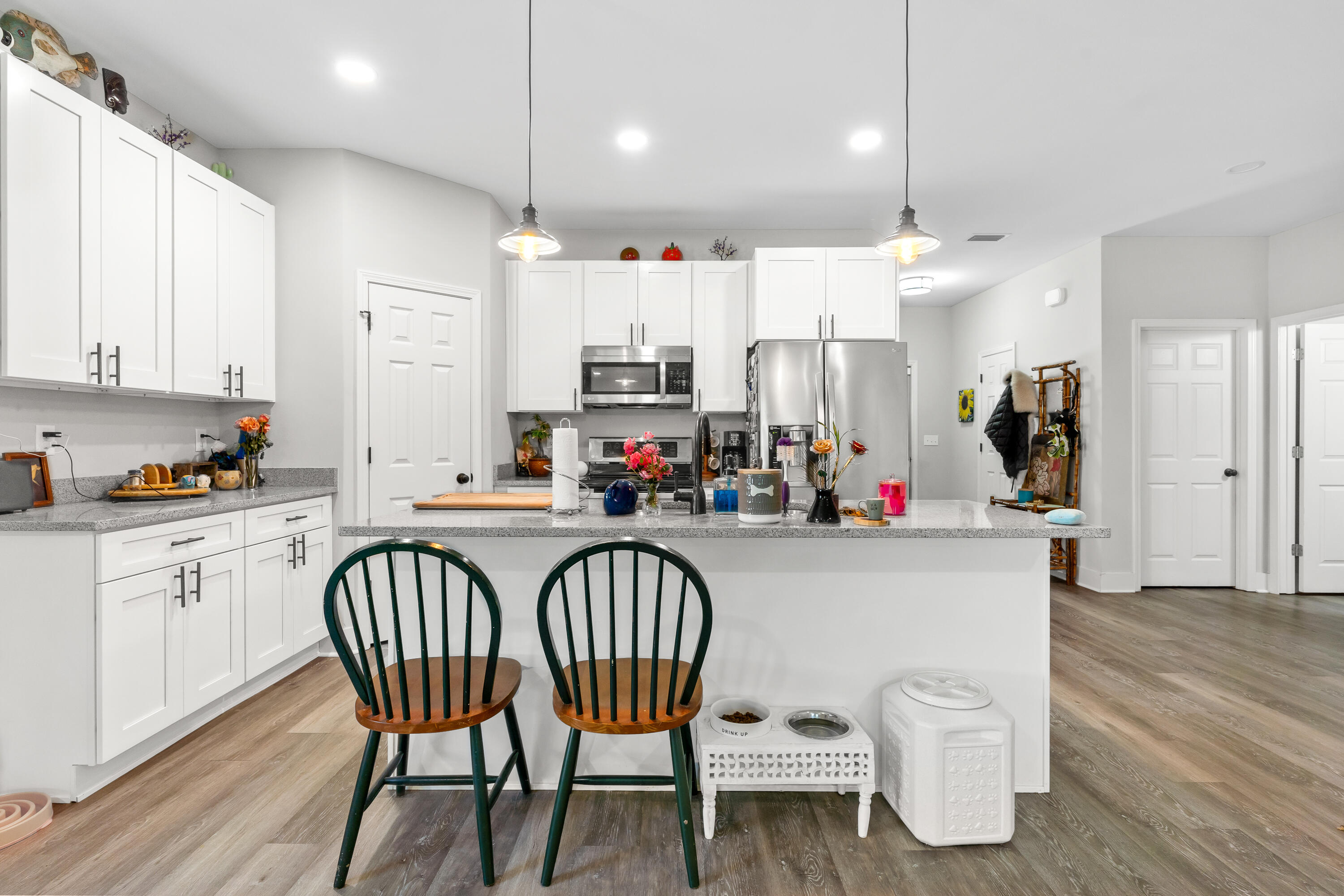 191 Indian Woman Road Santa Rosa Beach, FL 32459 - Photo 12 of 29 a kitchen with stainless steel appliances granite countertop a table chairs sink and cabinets