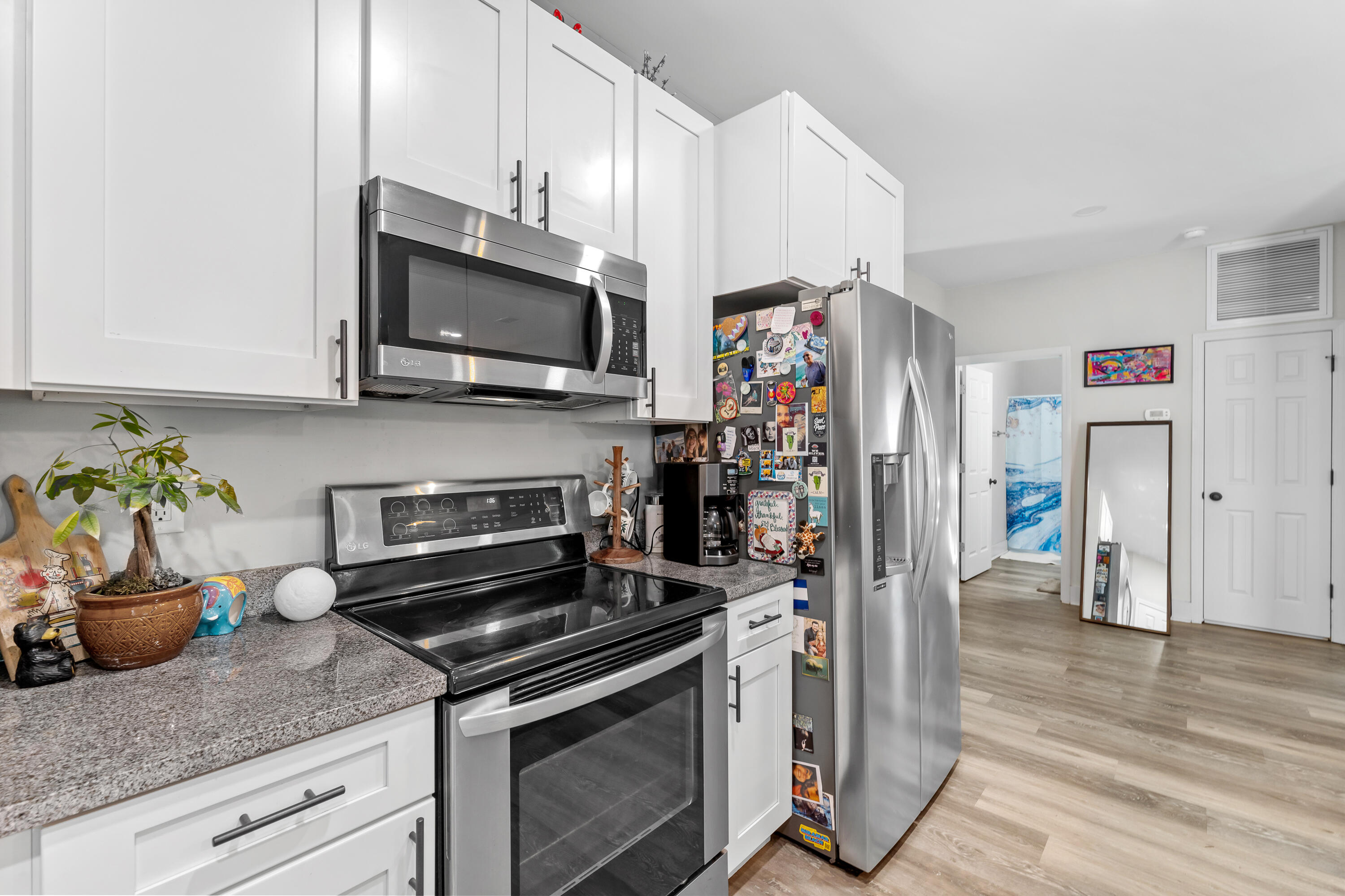 191 Indian Woman Road Santa Rosa Beach, FL 32459 - Photo 16 of 29 a kitchen with stainless steel appliances granite countertop a stove microwave and cabinets