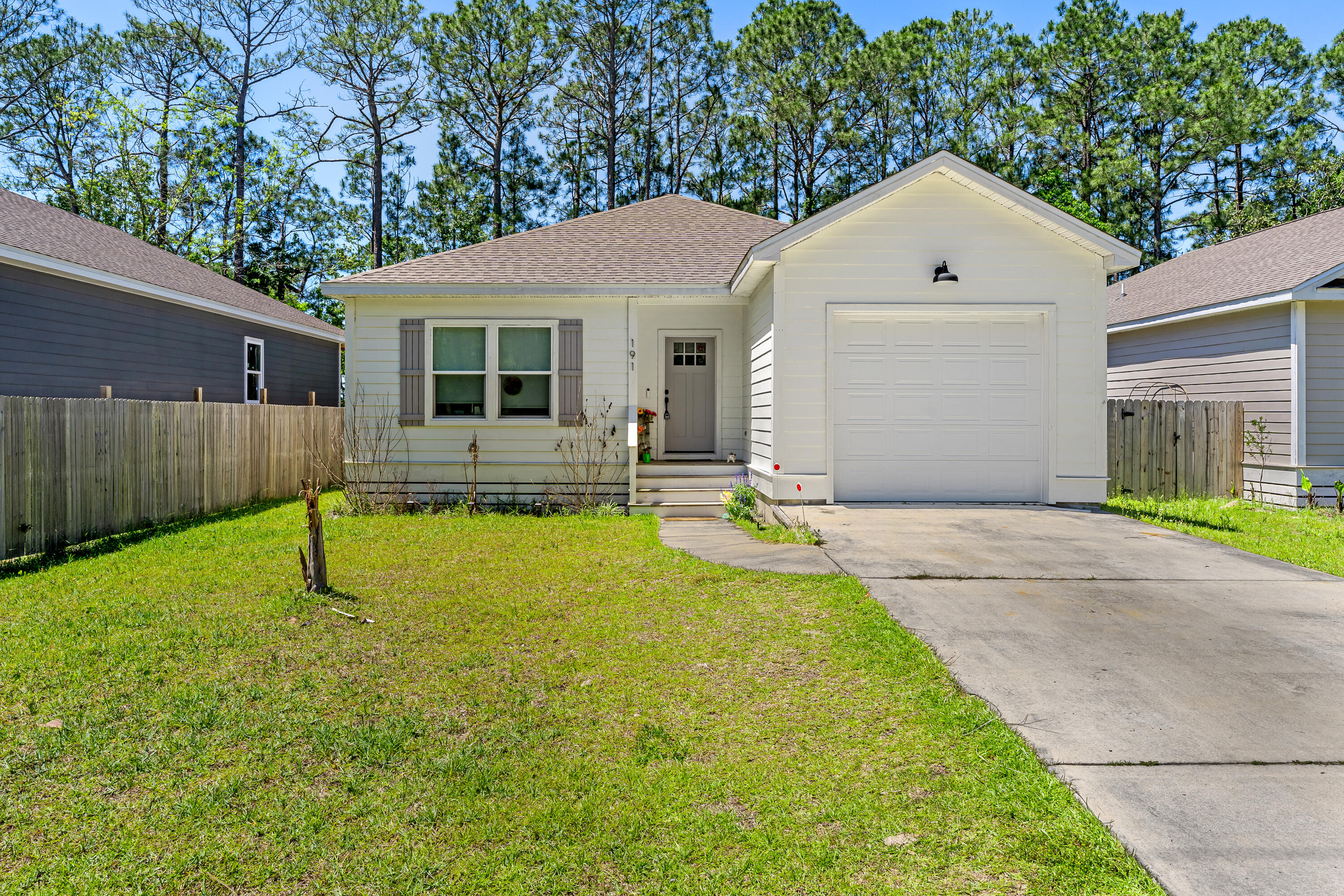 191 Indian Woman Road Santa Rosa Beach, FL 32459 - Photo 2 of 29 a swimming pool with outdoor seating and yard