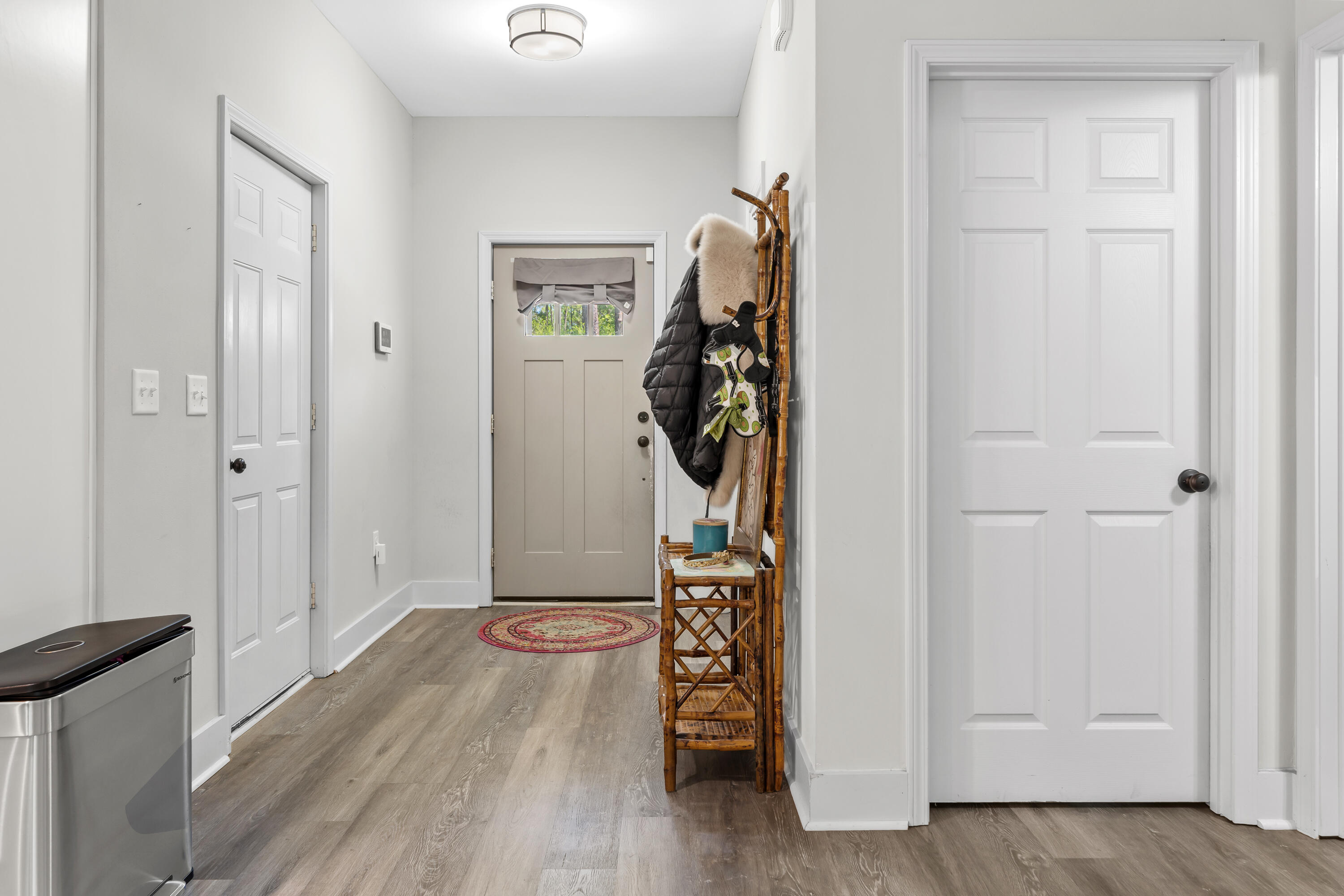 191 Indian Woman Road Santa Rosa Beach, FL 32459 - Photo 25 of 29 a view of a livingroom with wooden floor and a hallway