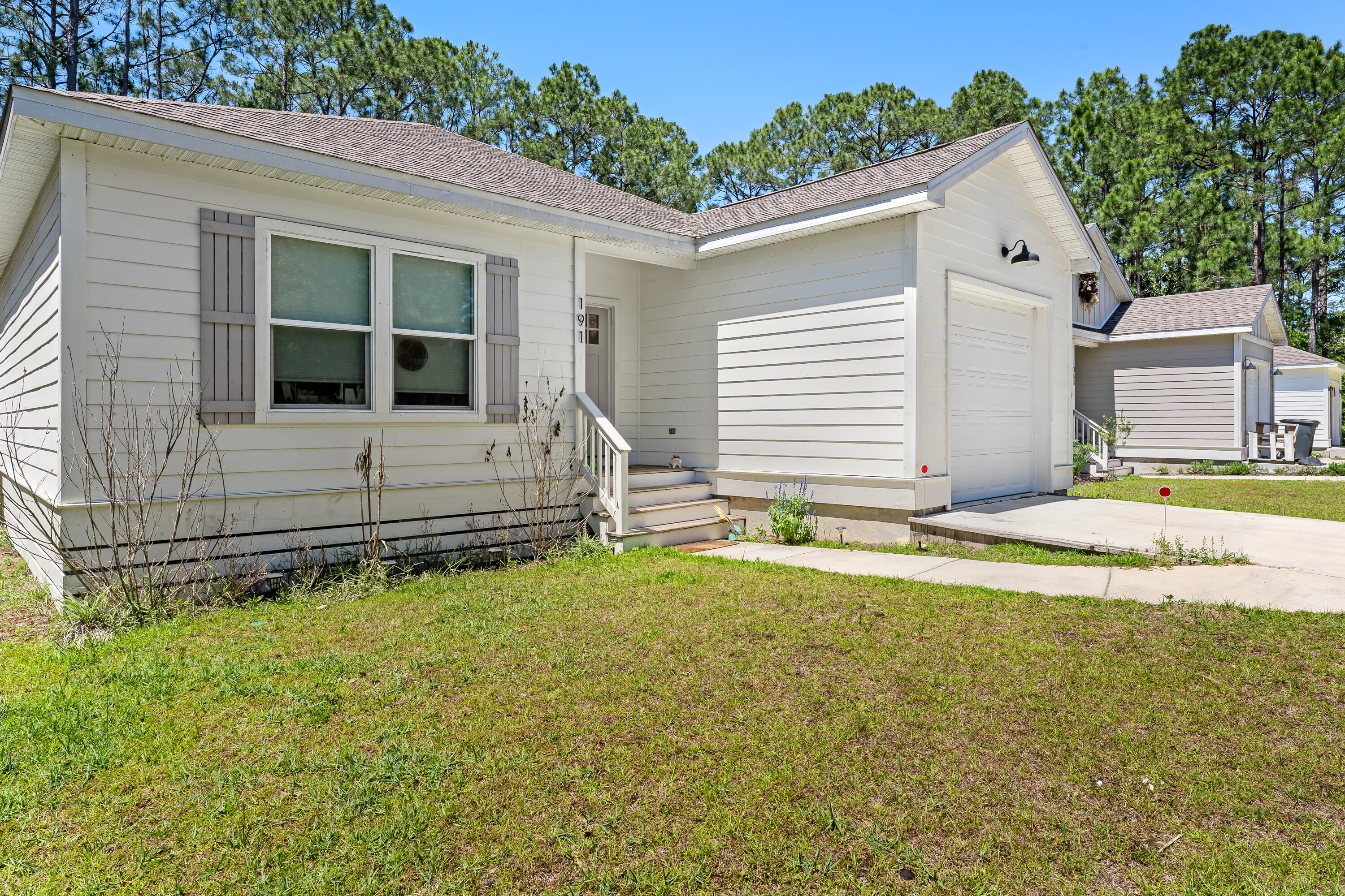 191 Indian Woman Road Santa Rosa Beach, FL 32459 - Photo 4 of 29 a view of house with backyard and trees in the background