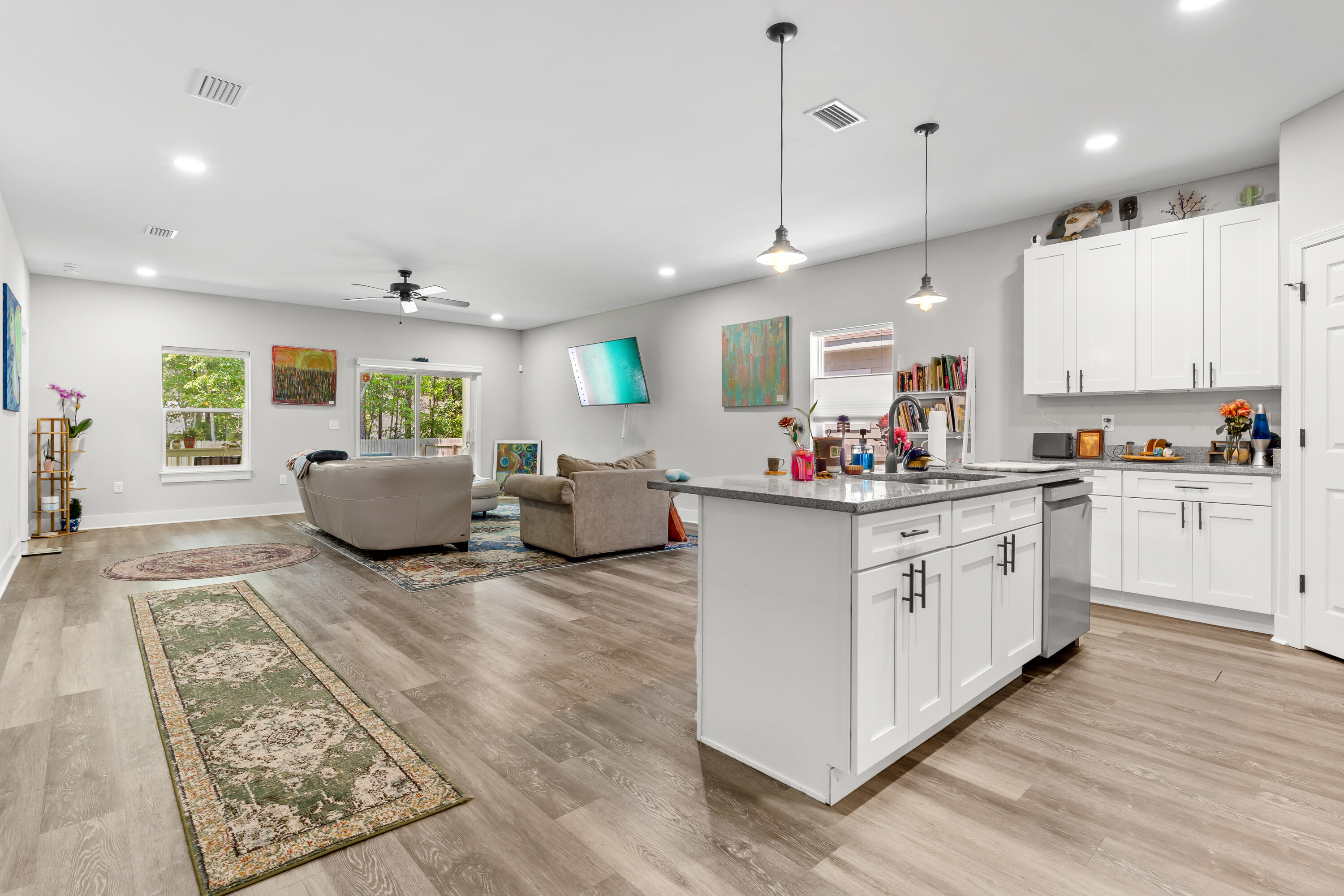 191 Indian Woman Road Santa Rosa Beach, FL 32459 - Photo 7 of 29 a kitchen with stainless steel appliances granite countertop a stove top oven a sink dishwasher and a refrigerator with wooden floor