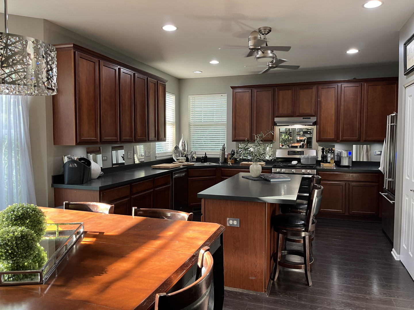 12922 Grande Poplar Circle Plainfield, IL 60585 - Photo 12 of 47 a kitchen with stainless steel appliances wooden cabinets granite counter tops a stove a sink and a refrigerator