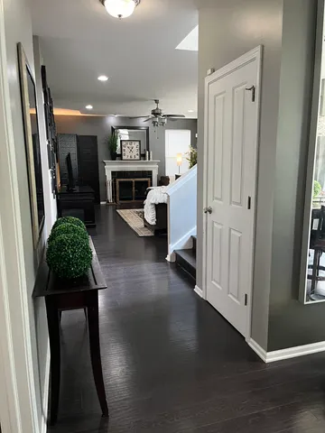 a living room with furniture a large window and a fireplace