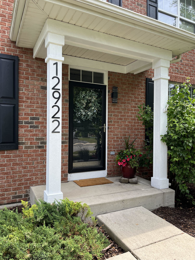 12922 Grande Poplar Circle Plainfield, IL 60585 - Photo 3 of 47 a front view of a house with a garden