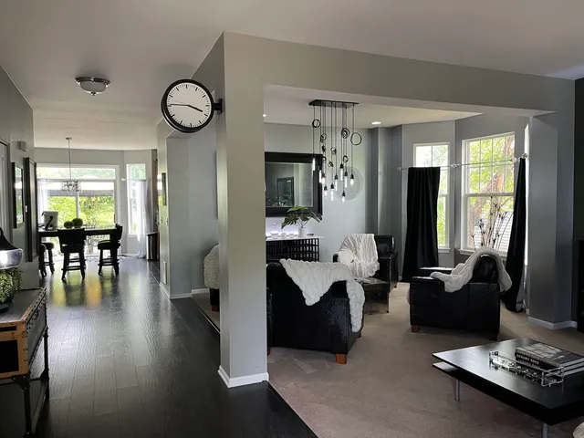 a living room with furniture potted plant and a chandelier
