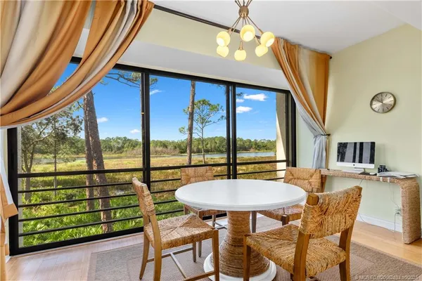 a view of a dining room with furniture window and outside view