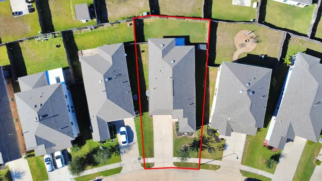 an aerial view of residential house with outdoor space and parking