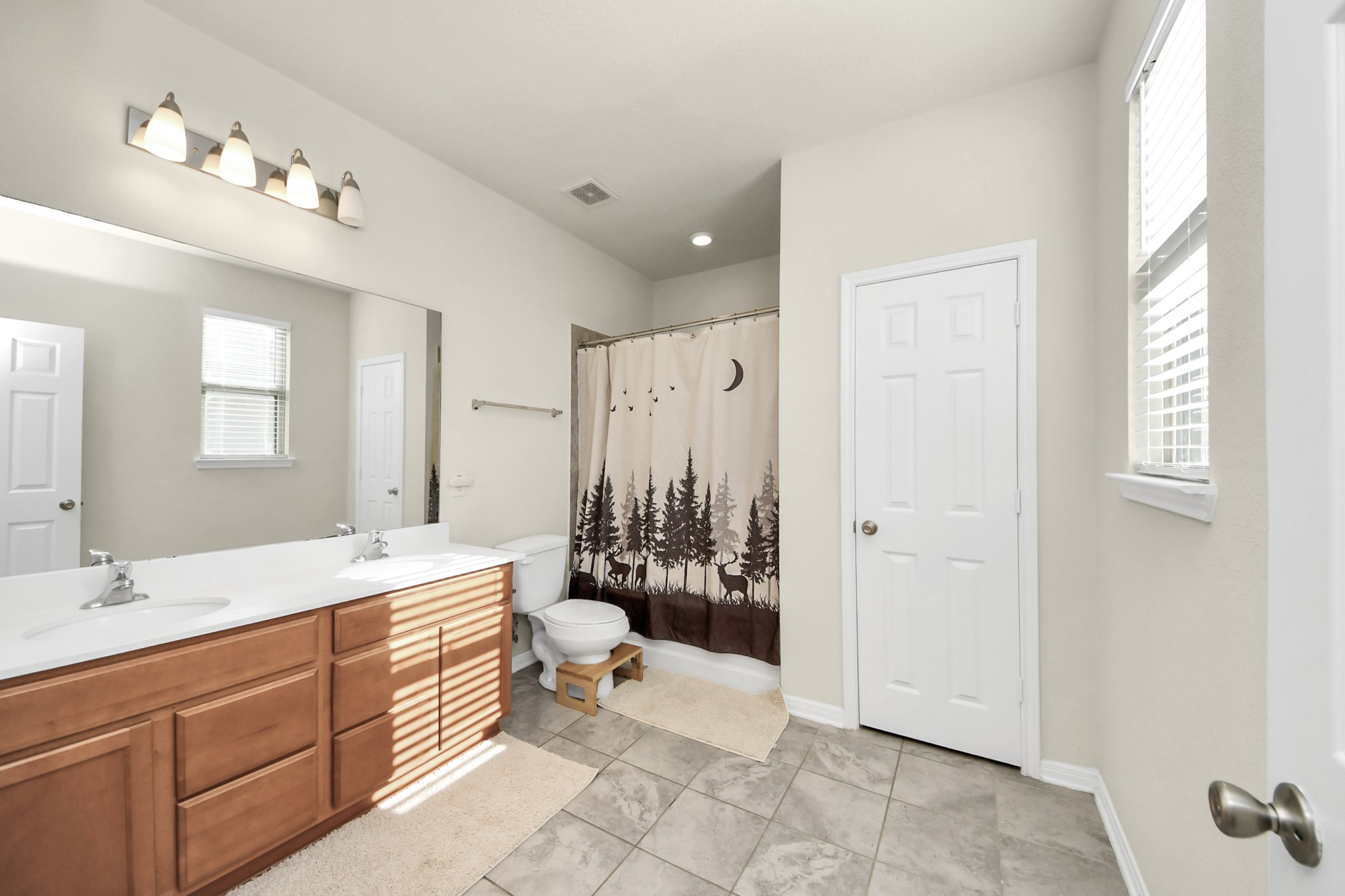 20830 Cullen Ranch Road Katy, TX 77449 - Photo 18 of 20 a spacious bathroom with a double vanity sink toilet mirror and bathtub