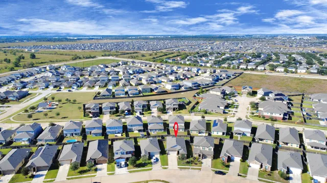 an aerial view of residential houses with outdoor space