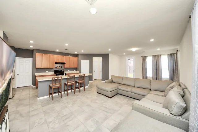 a living room with furniture and kitchen view