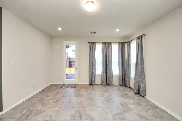 an empty room with windows and closet