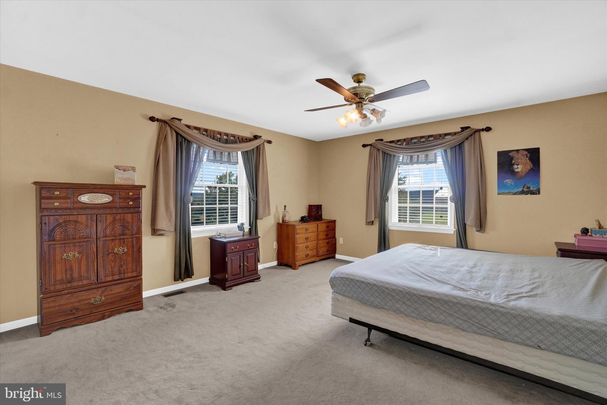 243 Bald Eagle Road Fawn Grove, PA 17321 - Photo 20 of 44 a spacious bedroom with a bed and a dresser next to a window