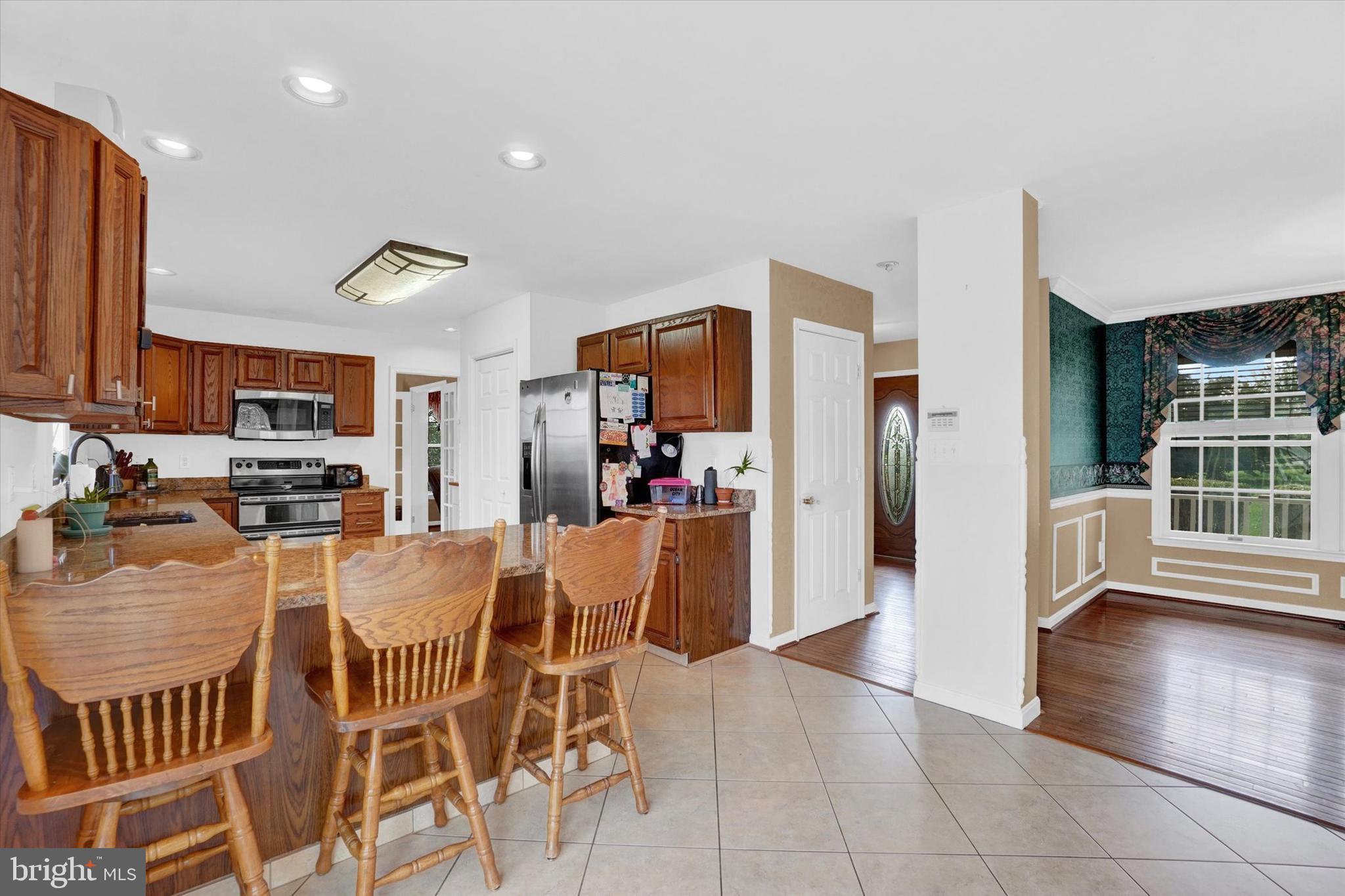 243 Bald Eagle Road Fawn Grove, PA 17321 - Photo 10 of 44 a kitchen with stainless steel appliances granite countertop a refrigerator and a stove top oven