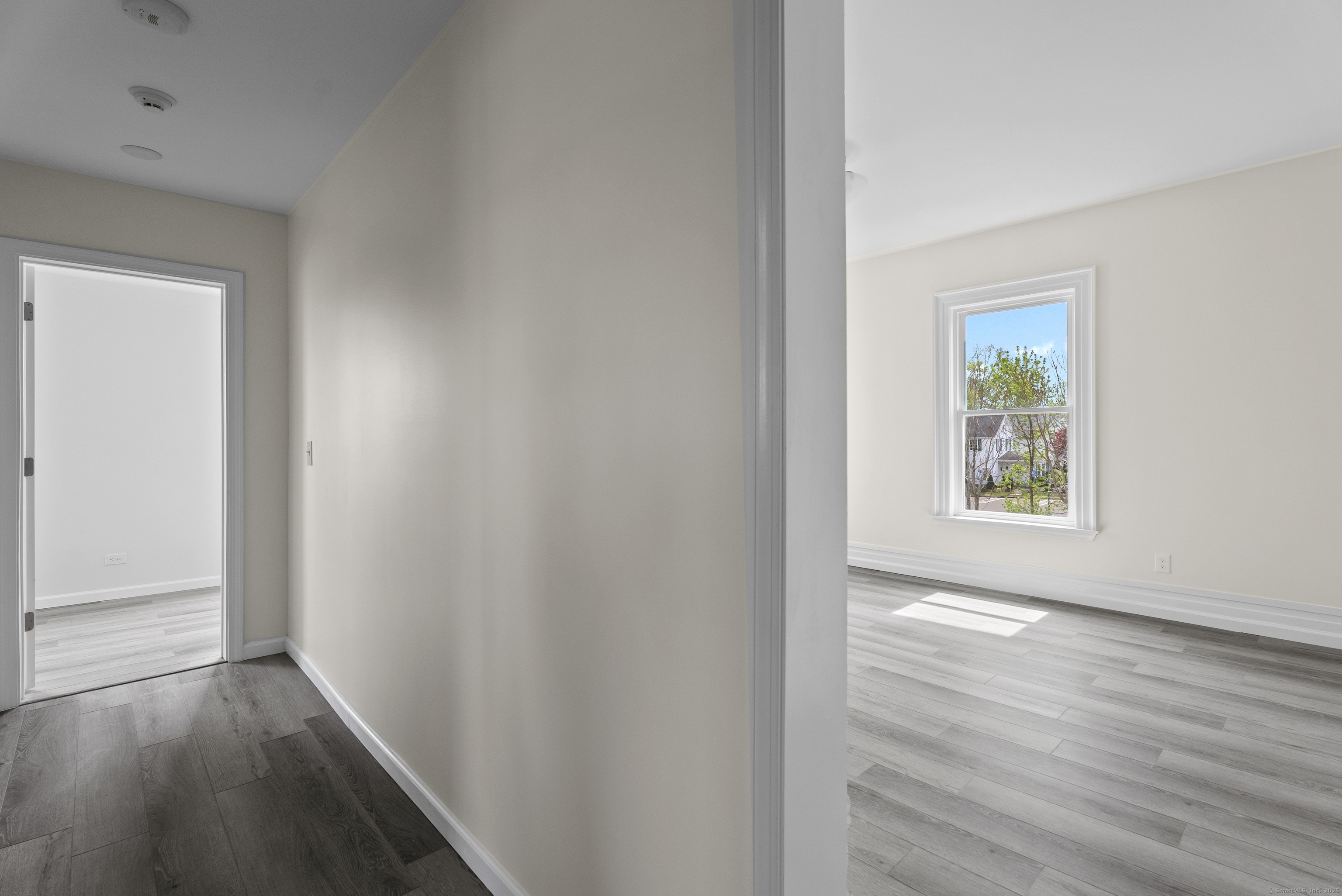 72 South Main Street, Unit 2C Wallingford, CT 06492 - Photo 3 of 10 a view of an empty room with wooden floor and a window
