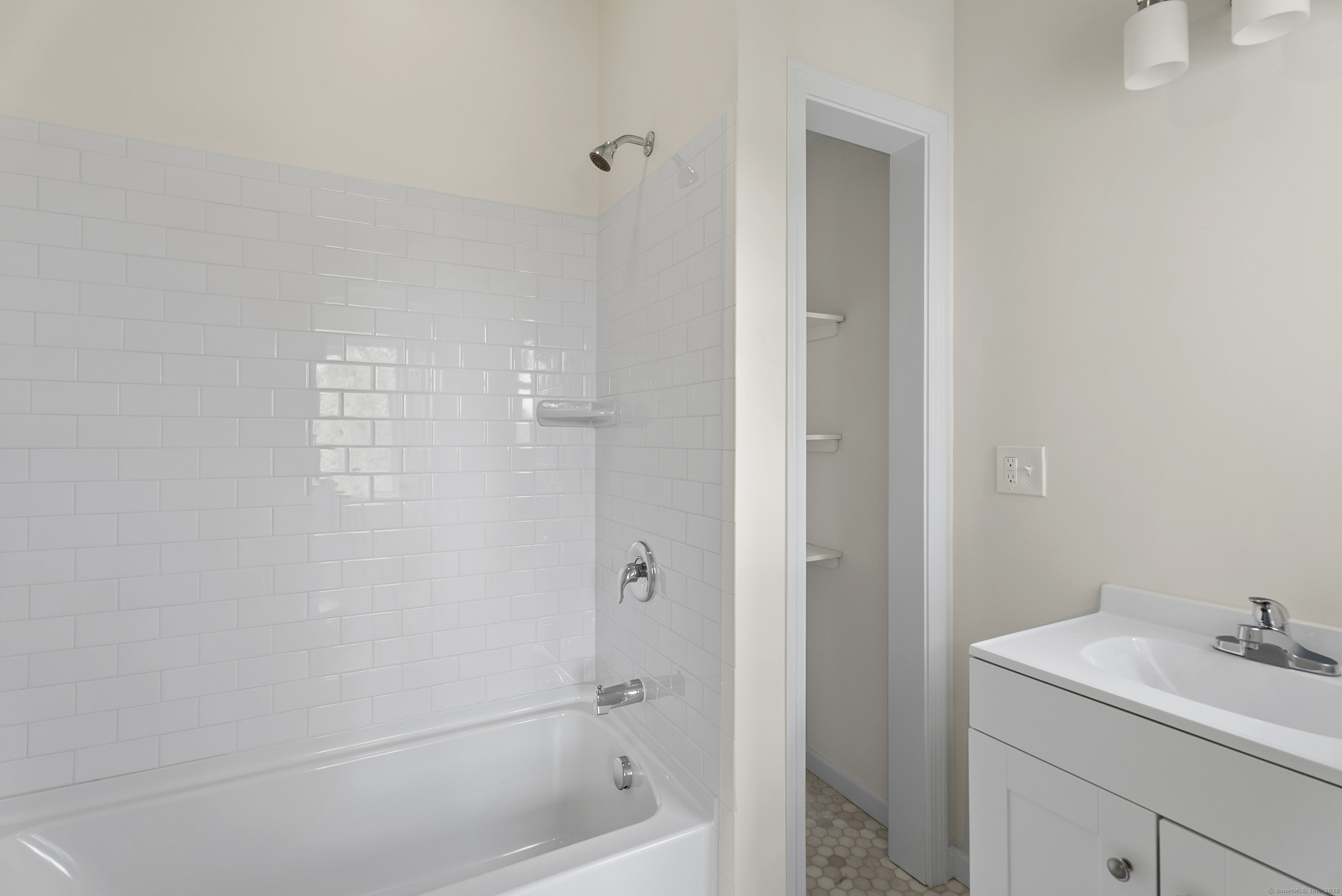 72 South Main Street, Unit 2C Wallingford, CT 06492 - Photo 7 of 10 a bathroom with a sink a toilet and shower