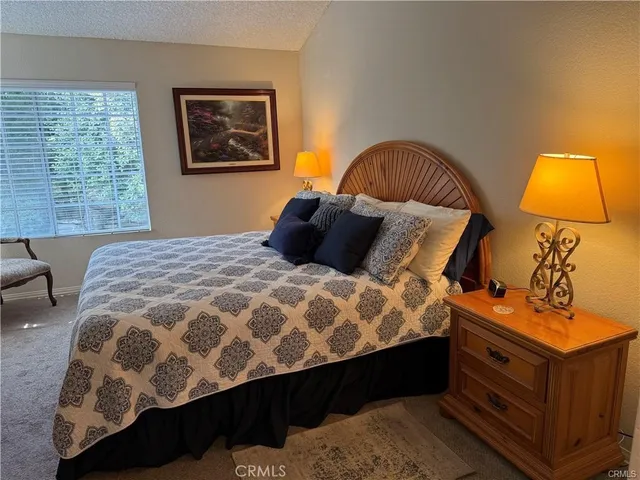 a bedroom with a large bed and a window