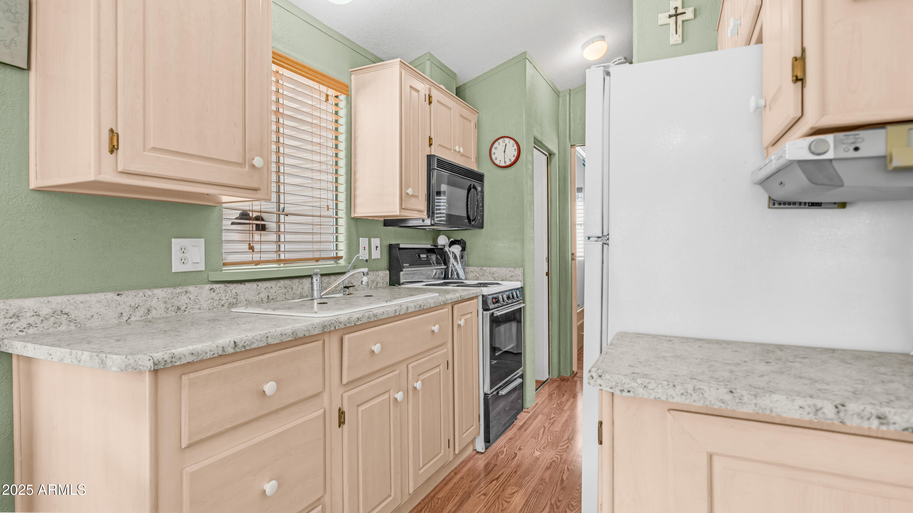 900 South Idaho Road, Unit 1106 Apache Junction, AZ 85119 - Photo 12 of 60 a kitchen with stainless steel appliances granite countertop a sink and a refrigerator
