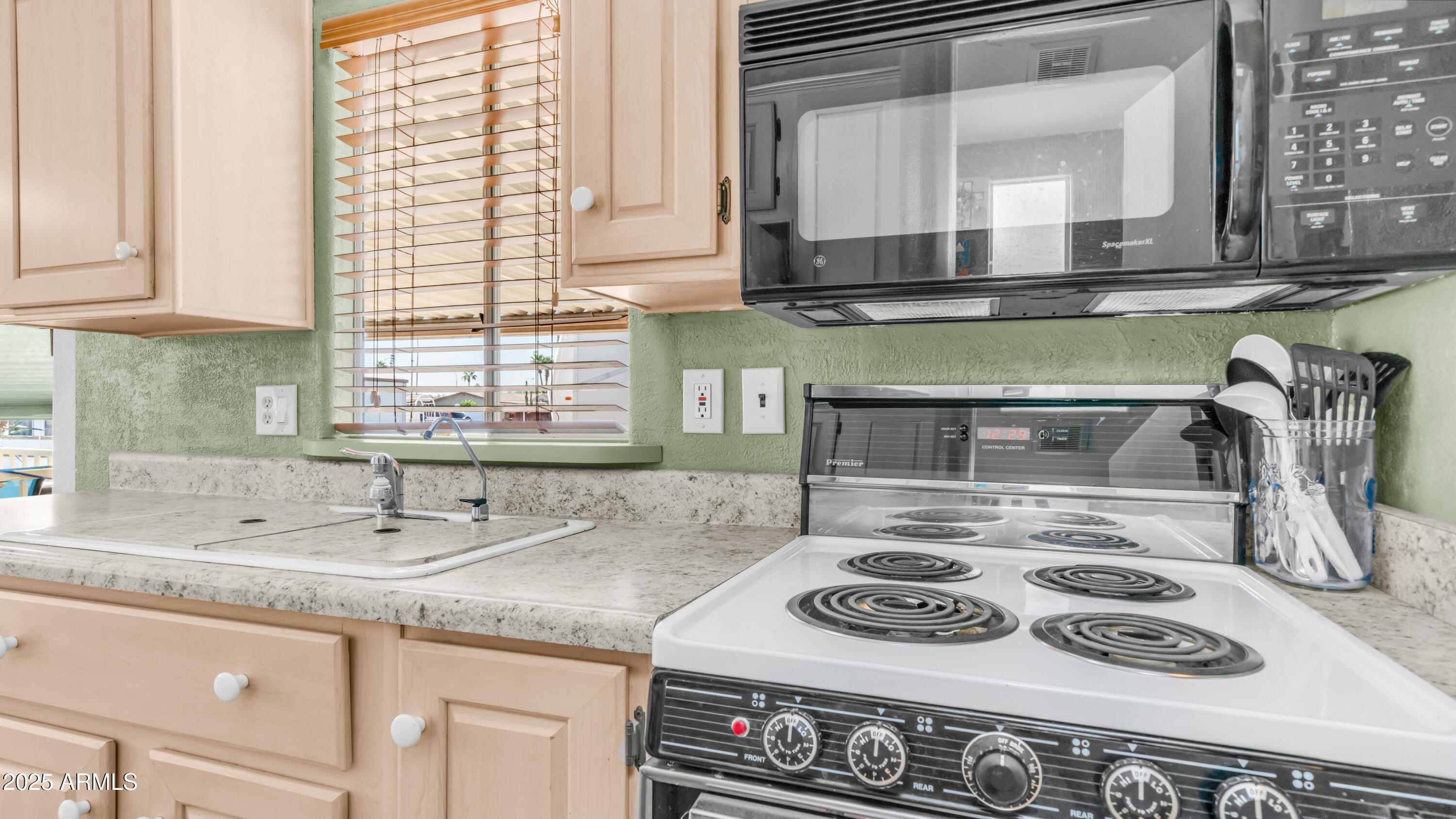 900 South Idaho Road, Unit 1106 Apache Junction, AZ 85119 - Photo 14 of 60 a kitchen with a stove and a sink