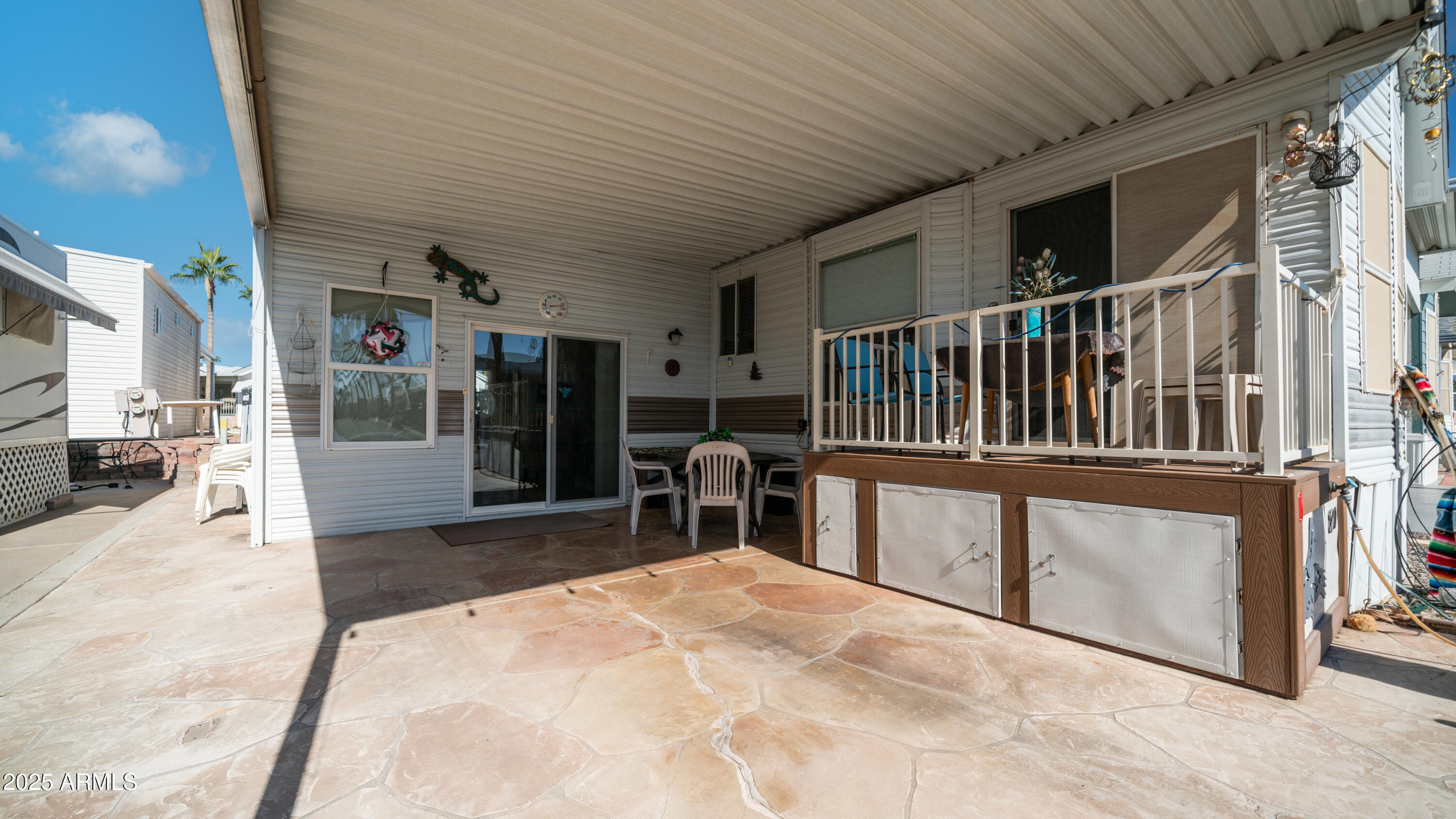 900 South Idaho Road, Unit 1106 Apache Junction, AZ 85119 - Photo 6 of 60 a bedroom with furniture and a large window