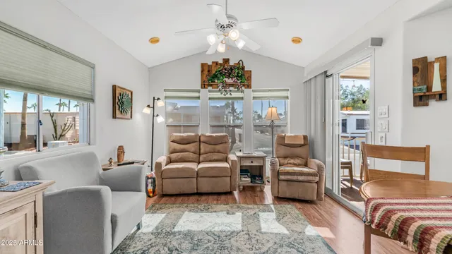 a living room with furniture a chandelier and a flat screen tv