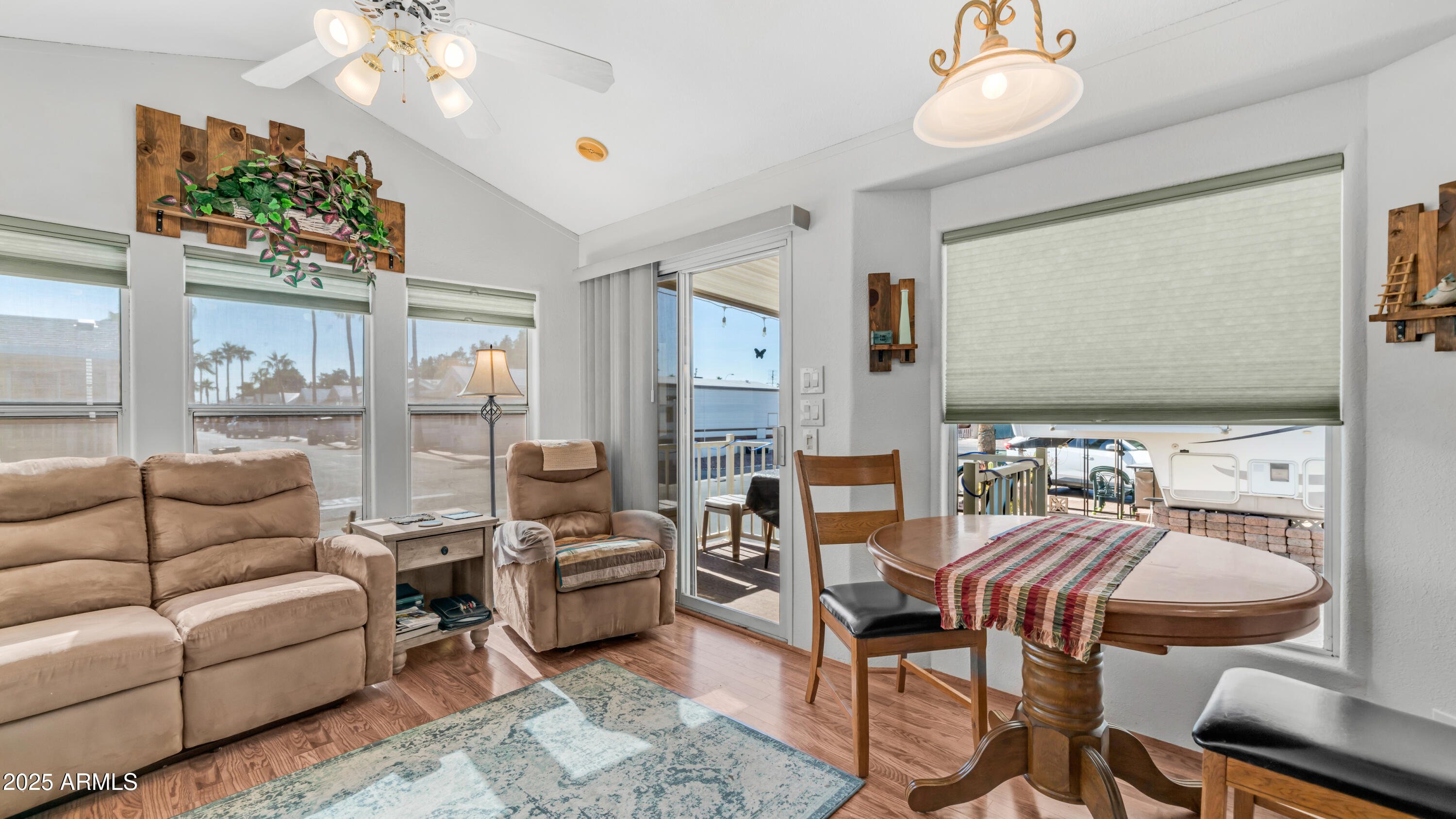 900 South Idaho Road, Unit 1106 Apache Junction, AZ 85119 - Photo 9 of 60 a living room with furniture a chandelier and a flat screen tv
