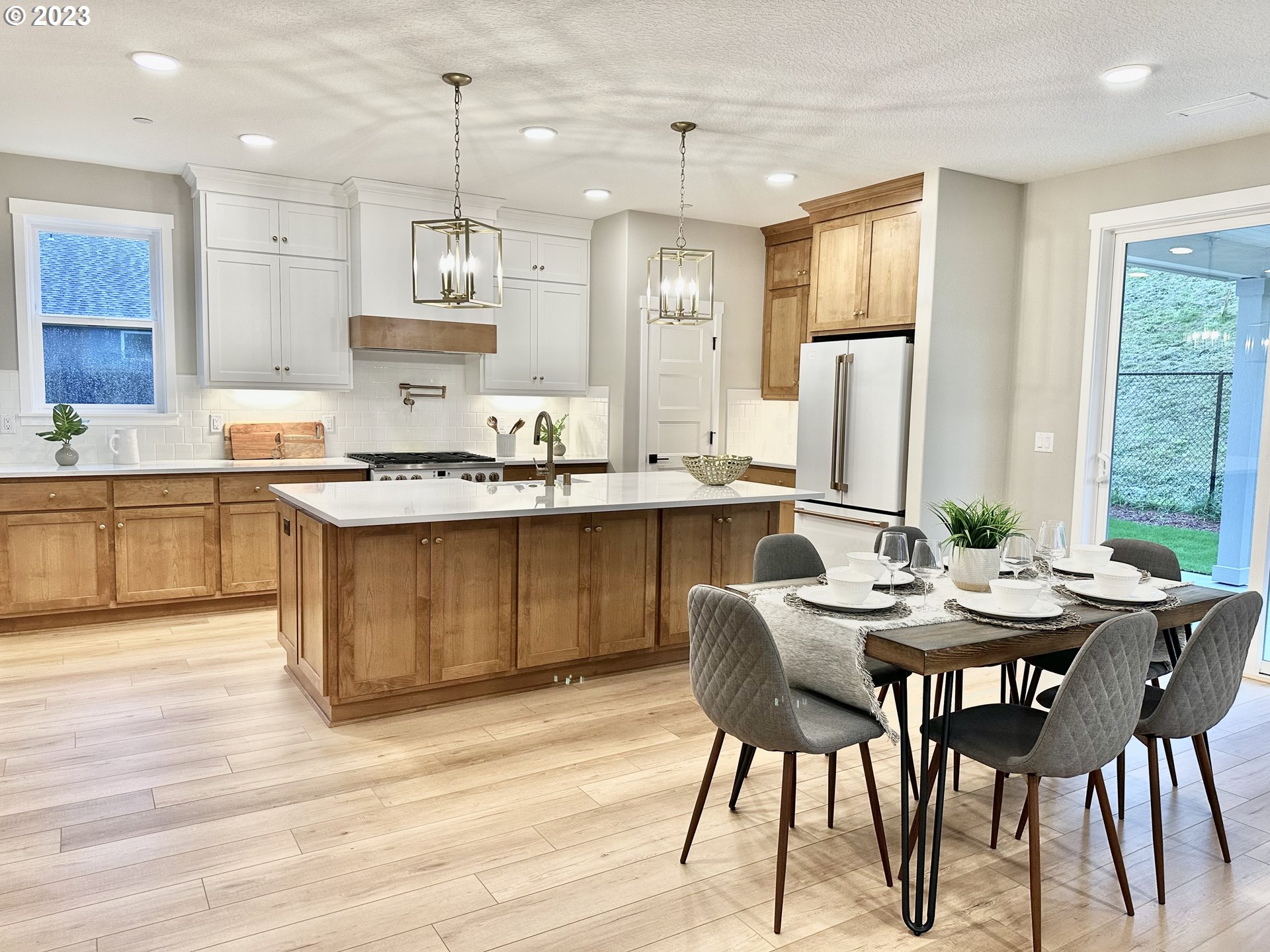 290 West Laurel Street Washougal, WA 98671 - Photo 6 of 20 a kitchen with stainless steel appliances kitchen island granite countertop a kitchen island a stove a table and chairs in it