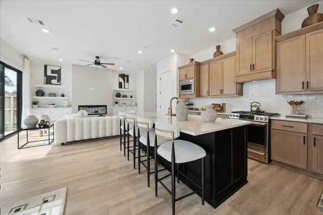 a bathroom with a sink a toilet a mirror and shower