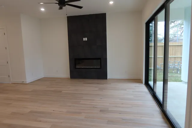 a living room with furniture large windows and a chandelier