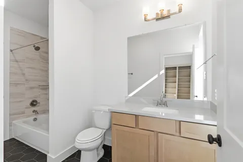 a bathroom with a double vanity sink toilet and shower