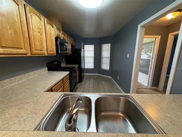 a kitchen with a sink a stove and a microwave