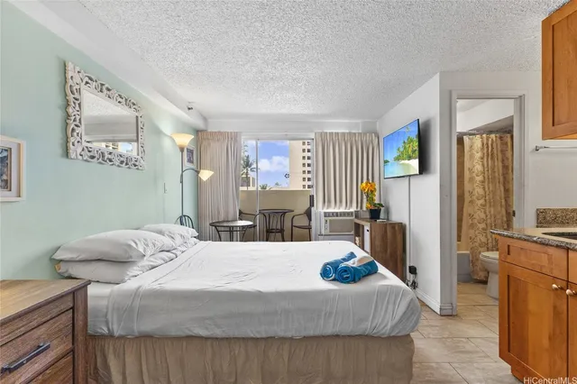 a bedroom with a bed and large windows